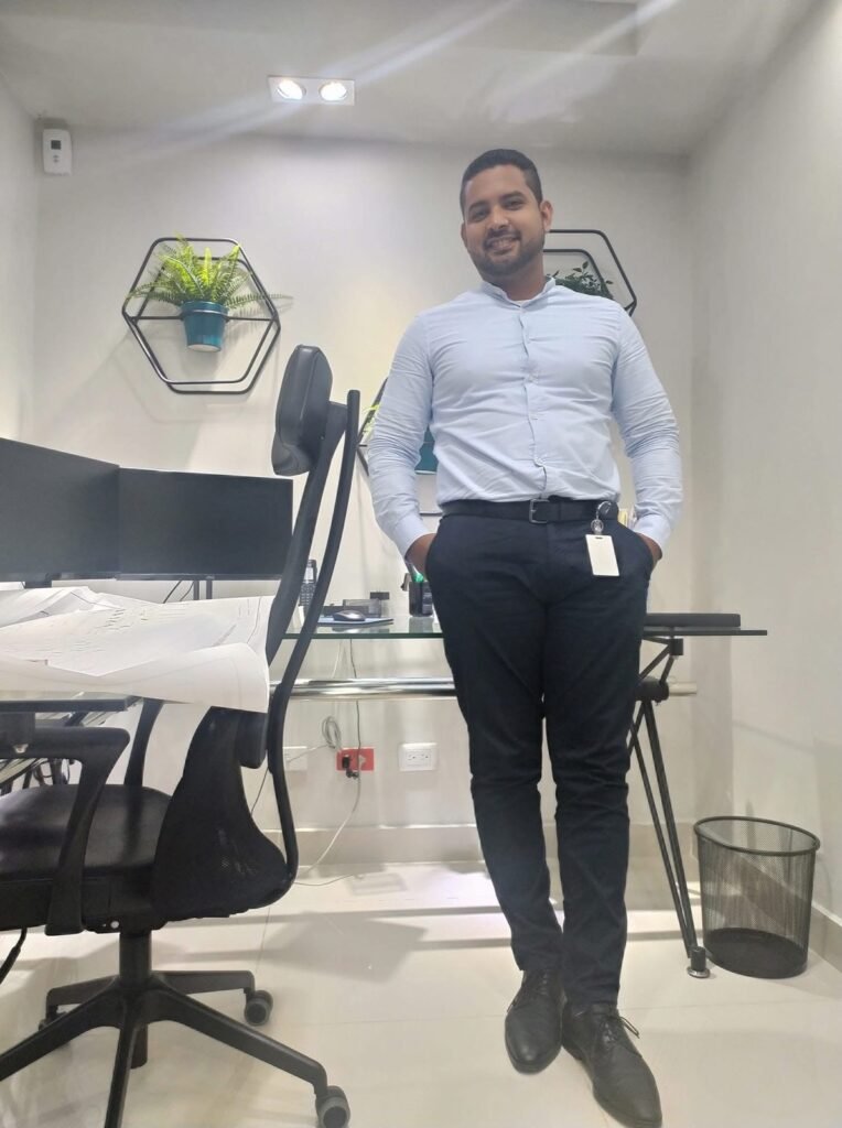 Vicente Rojas standing in the office